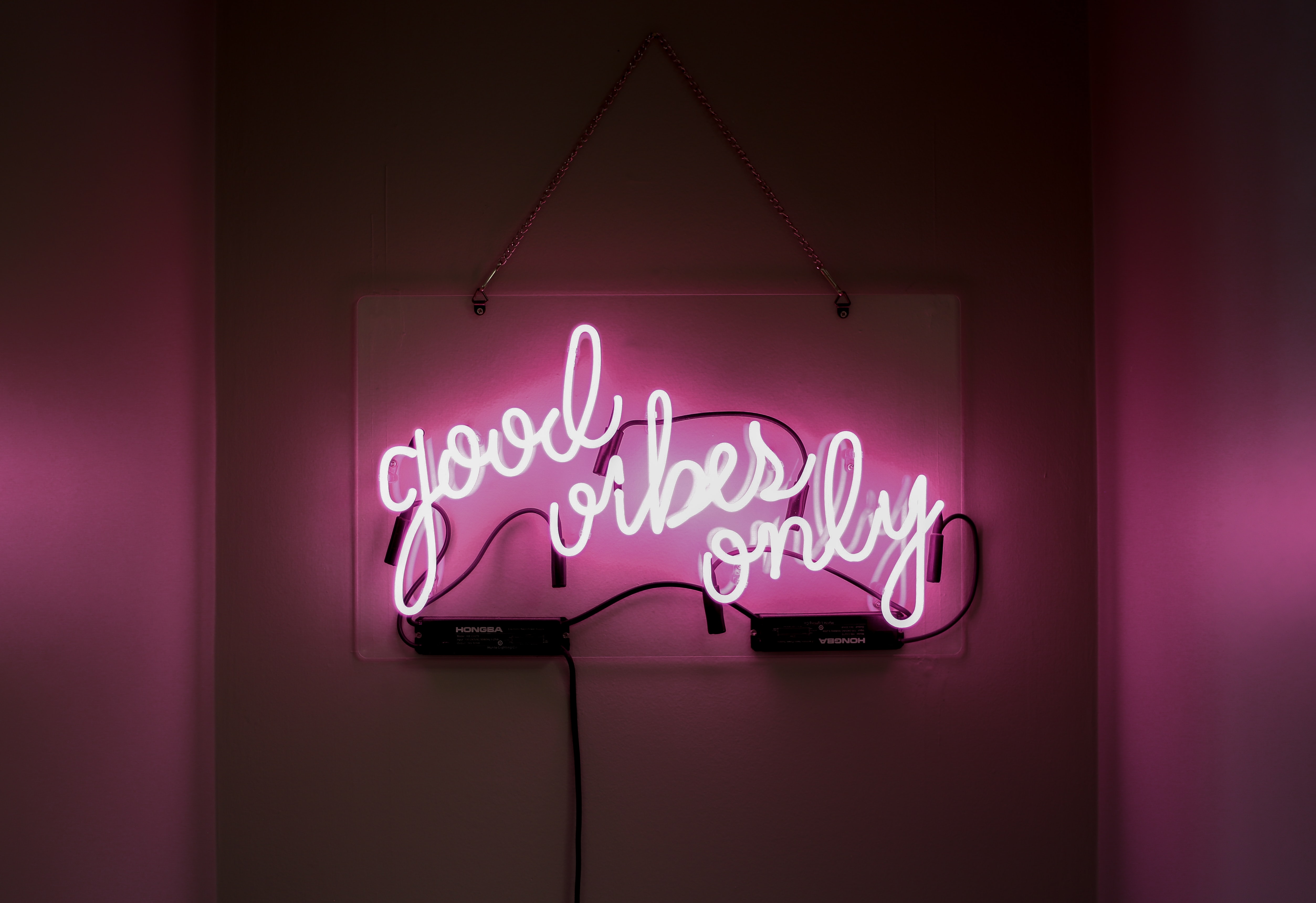 neon sign saying 'good vibes only' in a nightclub