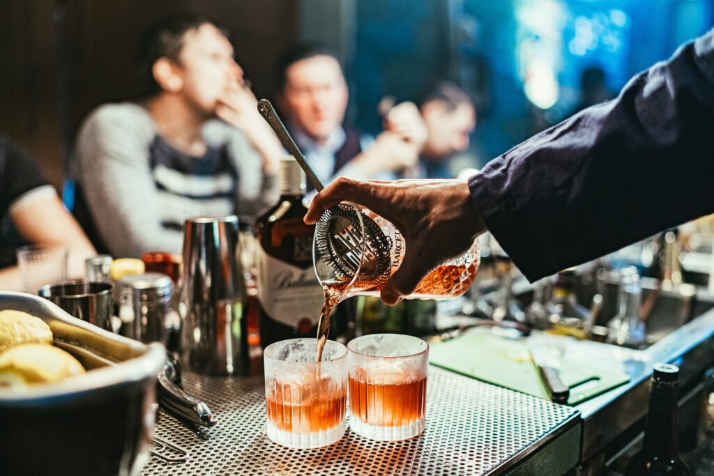 A bartender pouring a drink